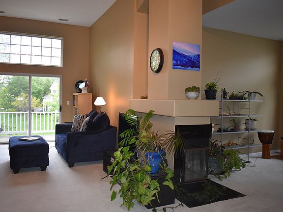 Open concept layout w/ living room & den separated by a 2-way fireplace