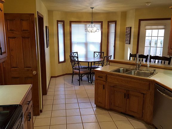 To the left of front entry.