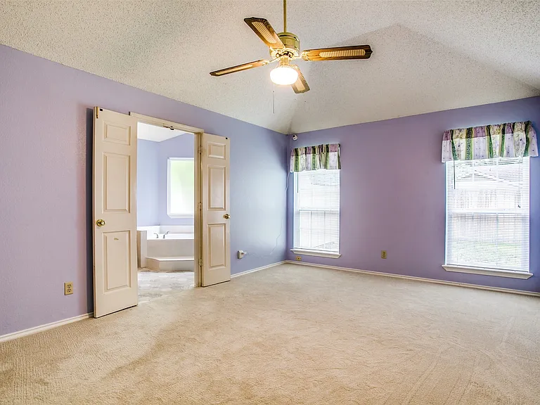And the primary bedroom . Spacious, windows ro the private backyard and opening up to the bathroom and door to backyard.