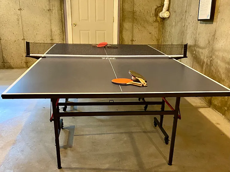 Ping pong anyone? The unfinished basement also includes 2 couches and a coffee table. Plenty of room to gather and lounge.