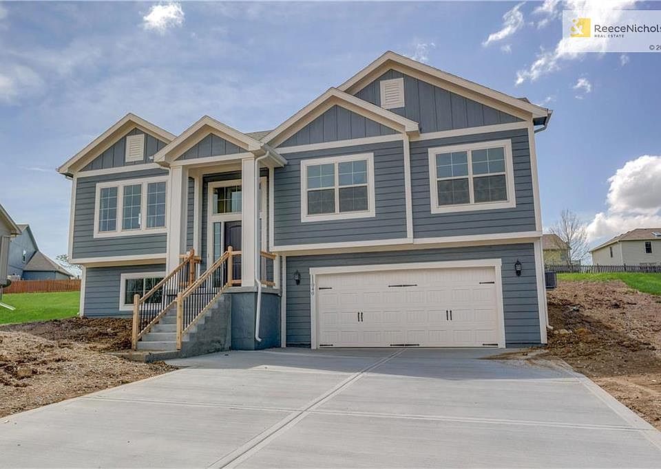 Carriage style steel doors with decorative hardware, pre-wired for door openers. Insulated fiberglass front door with sidelights and grills. Front landscape package per community requirements. Traditional front lap and stone veneer exterior.