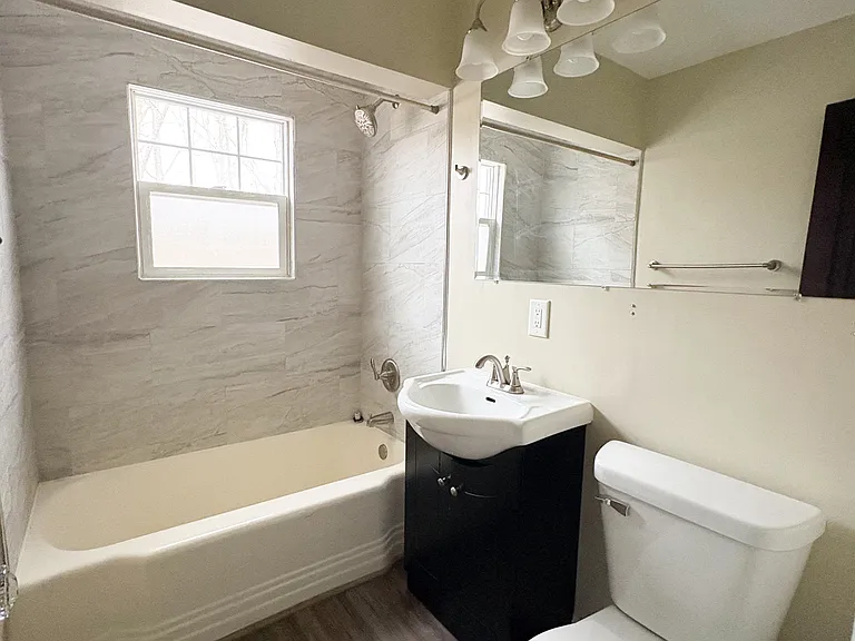 Bathroom with newer tiling in the shower.