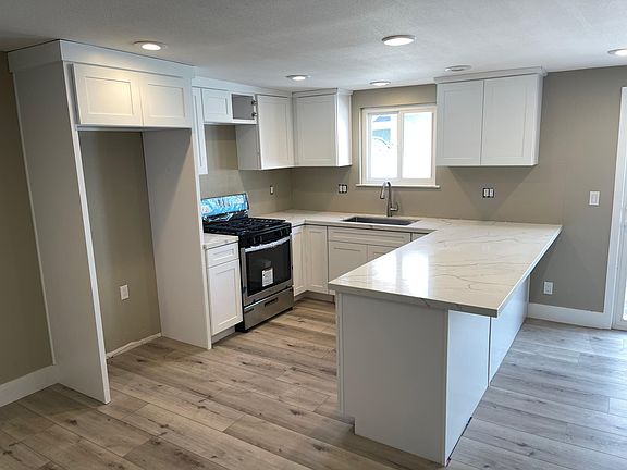 Brand new kitchen with quartz countertops.