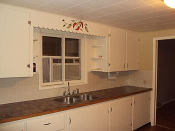 Kitchen with hardwood flooring. The gas ovenrange, refrigerator, washer and dryer are included. The main floor laundry room is off the kitchen.