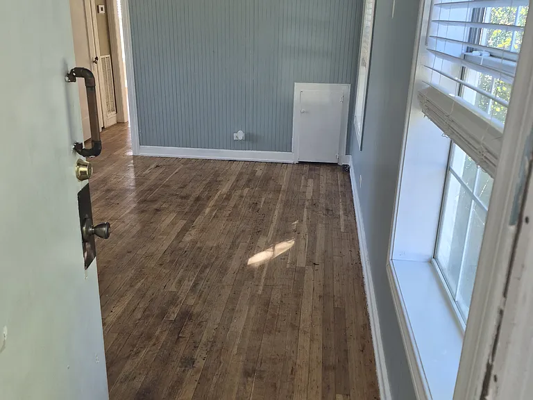 Living room from front door with light on.