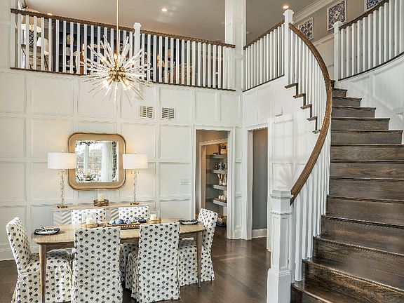 Statement Foyer and Dining Room with Grand Curved Staircase