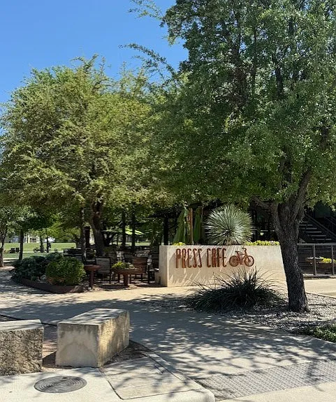 Nearby Local Favorite Press Cafe with Outdoor Seating Under Shade Trees