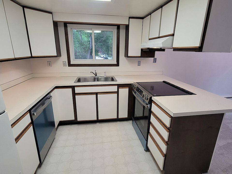 Lovely, bright kitchen with bar seating, open to living room.