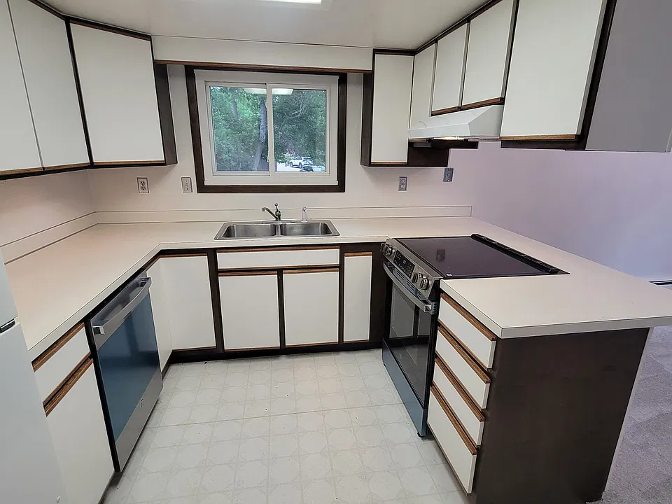 Lovely, bright kitchen with bar seating, open to living room.