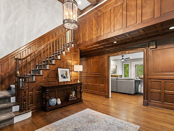 Rich wood wainscoting an impressive staircase.