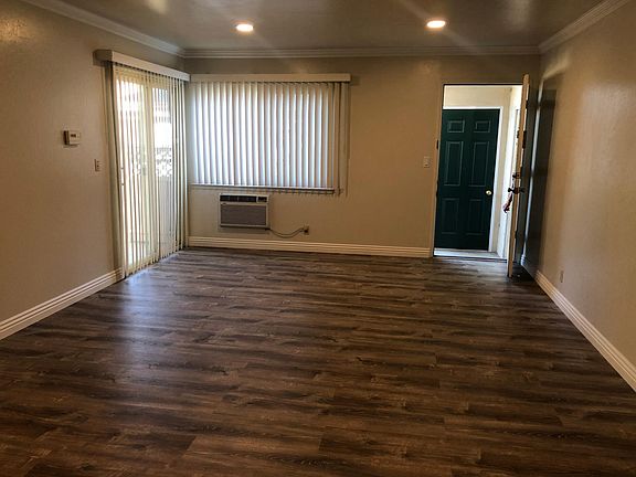 Living room showing entry door and patio sliding glass door