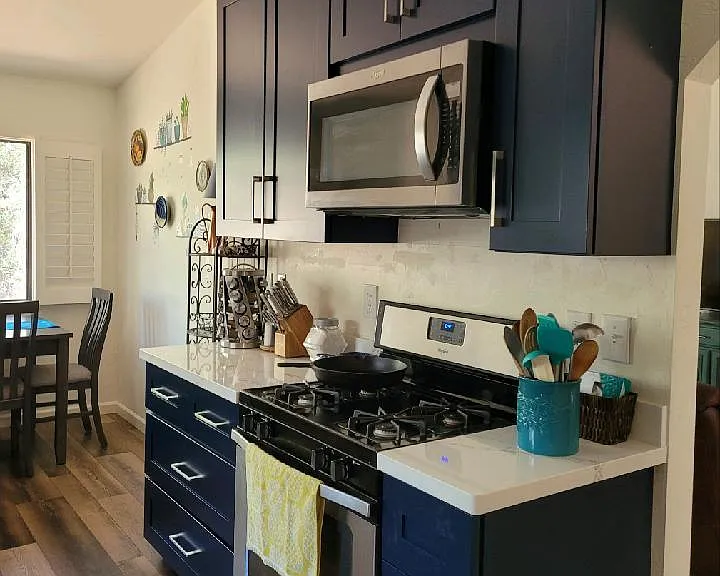 New kitchen cabinets and quartz countertop with gas stove and oven/microwave