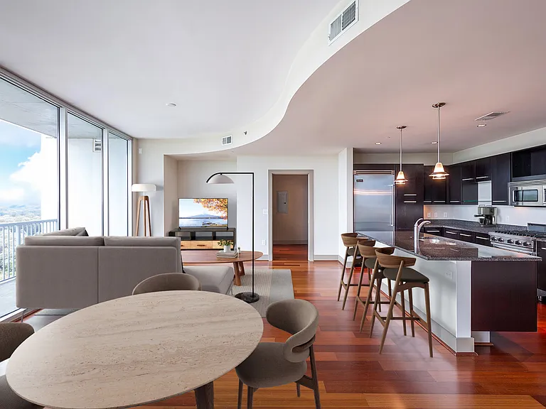 Spacious living room features floor-to-ceiling windows with amazing views of Buckhead