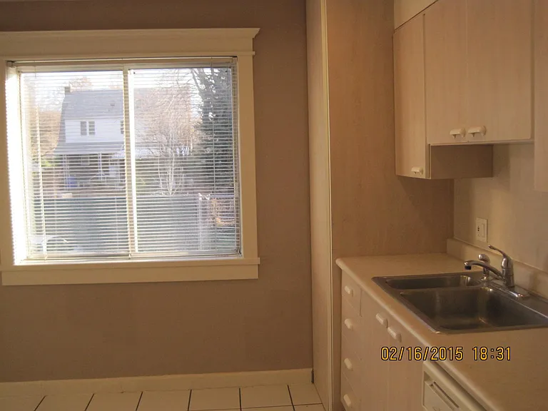 Kitchen overlooks Back Parking Lot