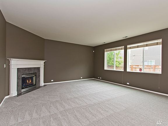 Spacious great room with gas fireplace and open flow into kitchen - perfect for both hosting and everyday living