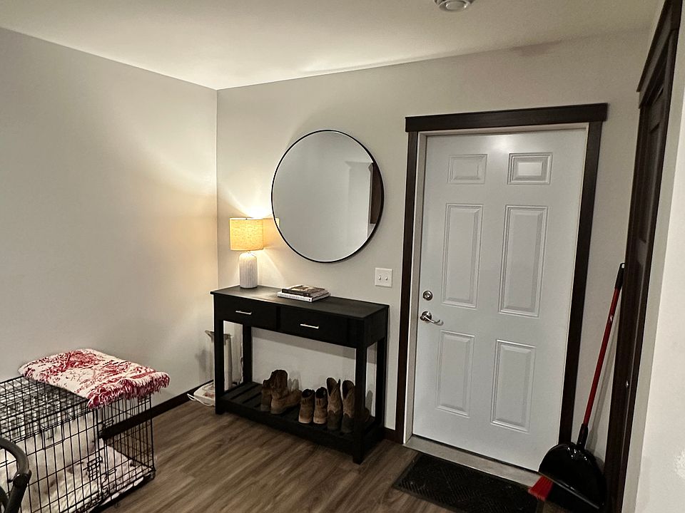 Door leading to full size 2 car garage big enough to fit two full size trucks. On the right is a large walk in storage closet also stores the new hot water heater.
