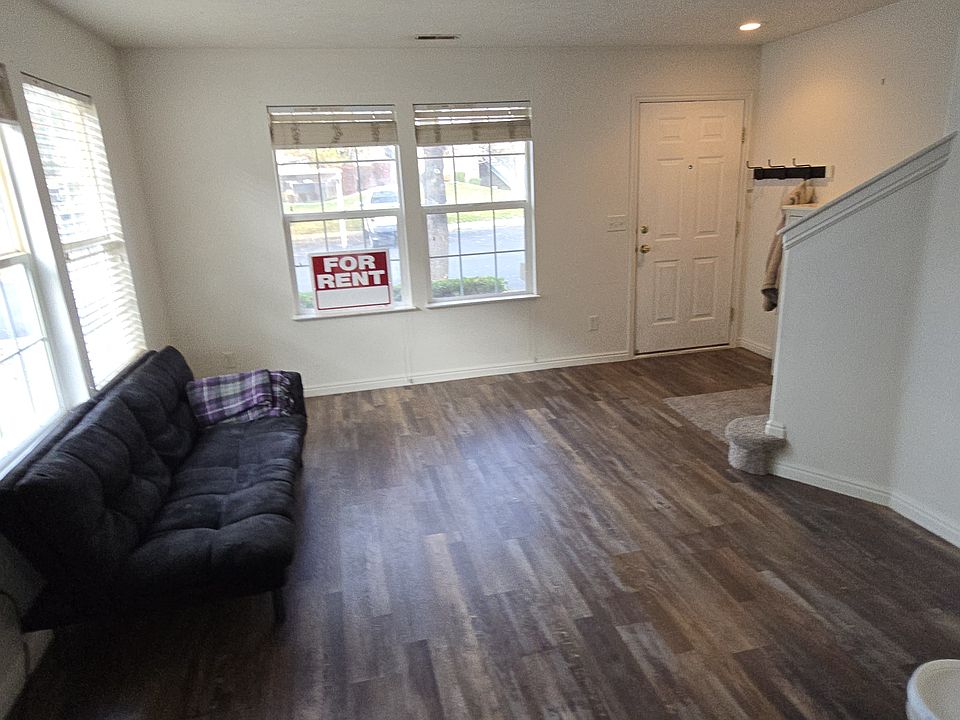 View from dining area towards lounge area, front door and stairs up to 2nd floor. Loads of natural light.