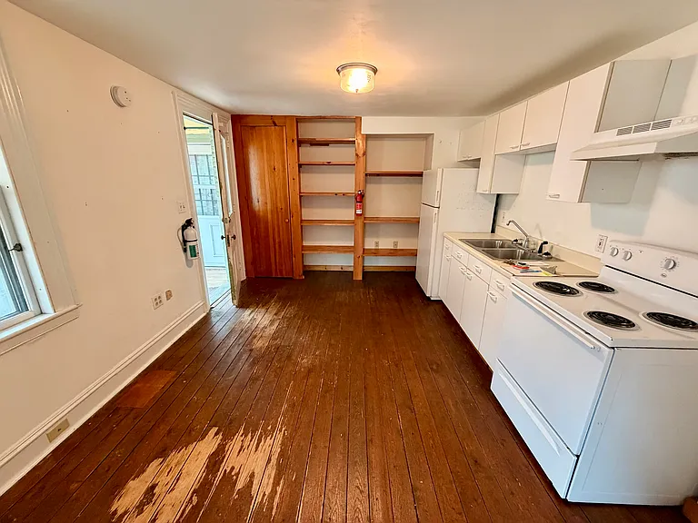 Looking into kitchen space. Entrance to apartment to the left.