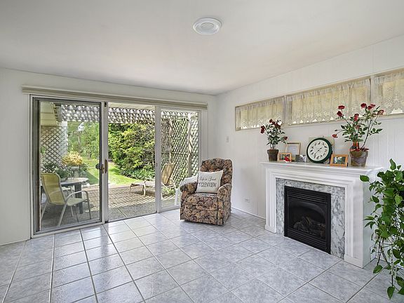 Sun porch with remote gas fireplace & access to the private patio.