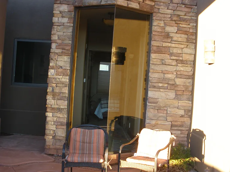 another view of side patio from the outside between the kitchen, casita and front door