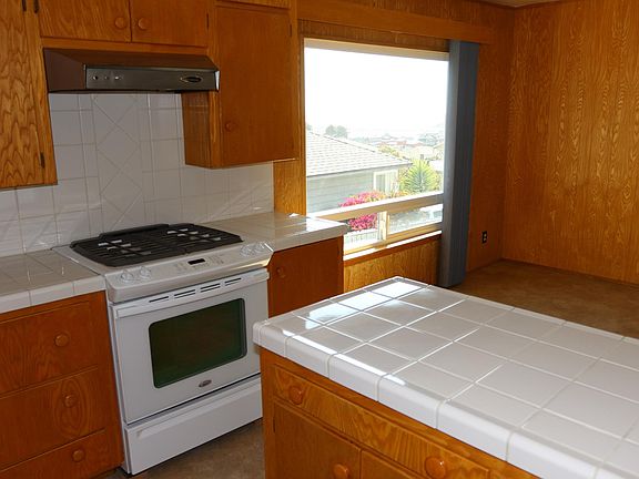 Kitchen countertops and island view window to the ocean