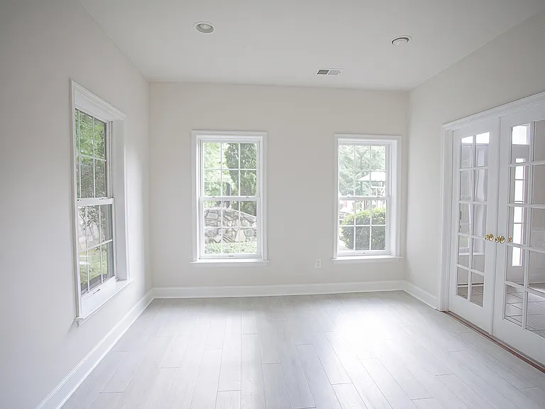 Elegant sun filled bonus room / office space with french doors on the ground level, with gorgeous afternoon light