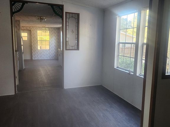 Standing in Entry, immediately in front dining area. Then looking into kitchen where the kitchen nook is at the back wall along with the laundry room. Covered parking on side entry.