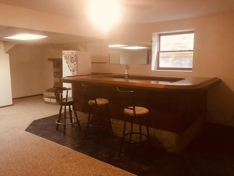 A beautiful solid oak bar! 
Extra fridge, too.
Lots of light