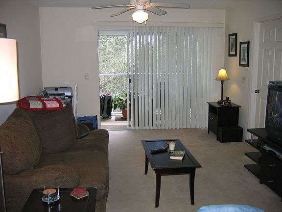 Large living area with access to porch overlooking golf course.