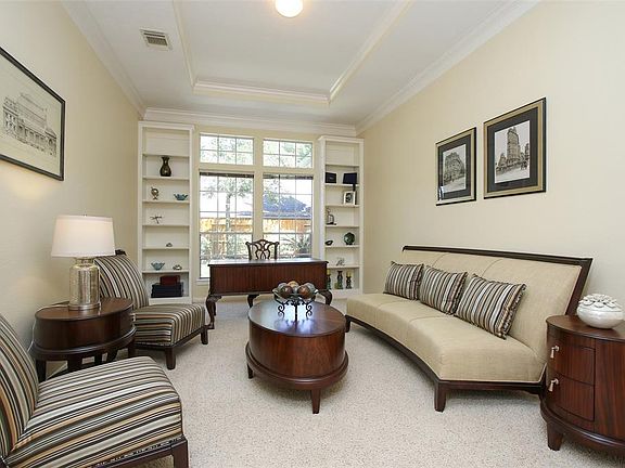 Formal Living tastefully appointed and with outdoor views.