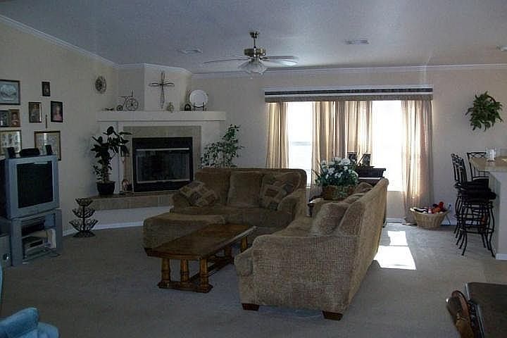 Family Room
						:
						Lovely fireplace and tray ceilings with archways and double-doors.