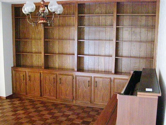 Built-in book shelving and cabinets in the living/library room.