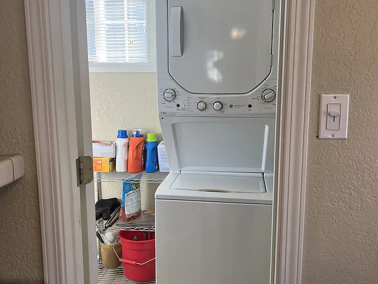 Separate Laundry room with stack washer/dryer
