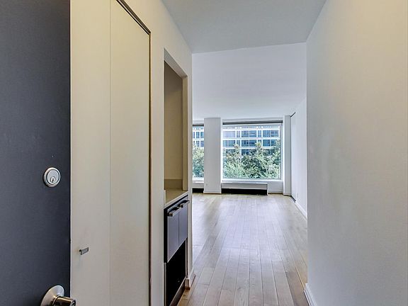 Entry way with large coat closet and hardwood floors throughout