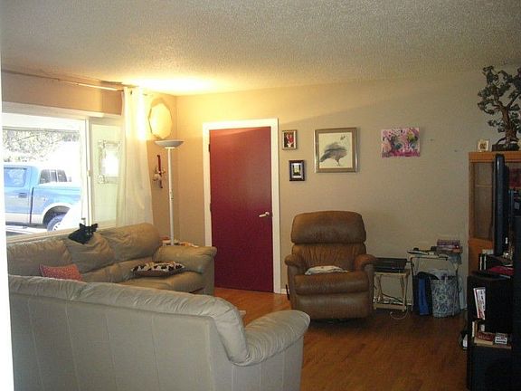 Spacious living room plus another large rec room/family room with gas fireplace and french doors to another deck.