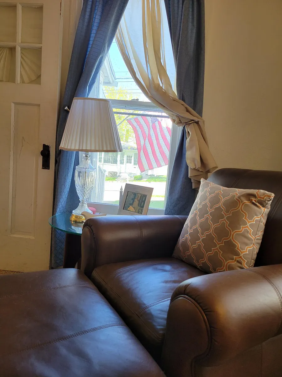 Comfy reading chair... read, and watch the world go by.. kids walking from school, people walking dogs... flag waves in wind. - W 6th St