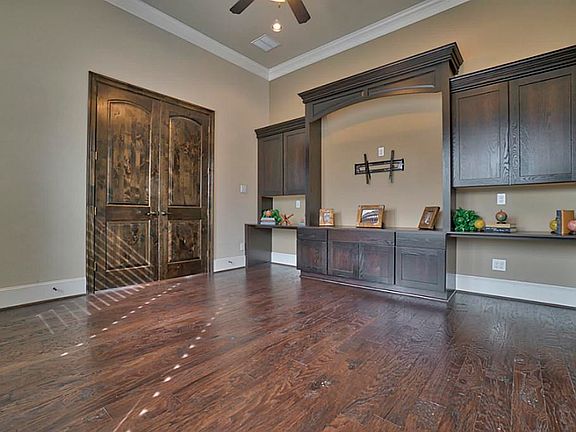 The study/office is located just off the entry of the house.  Large, two-panel Roman arch double doors welcome you into this charming study.