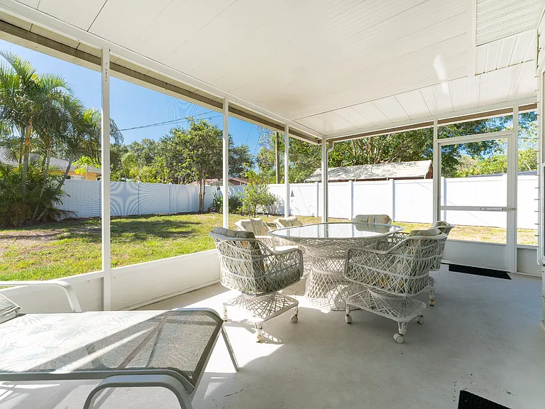 Large wrap around screened lanai overlooks the private backyard