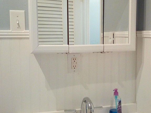 Bath vanity with tri-fold mirror above