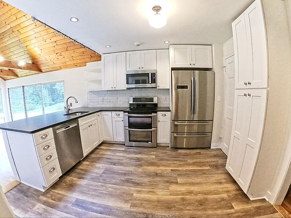 Fully renovated open kitchen with high end stainless steel appliances