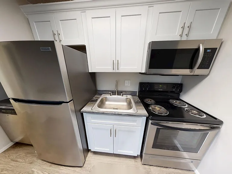 Enjoy a fully equipped kitchen with stainless steel appliances, modern cabinetry, and sleek countertops in The Dickenson floor plan at Aspen Chase Apartments.
