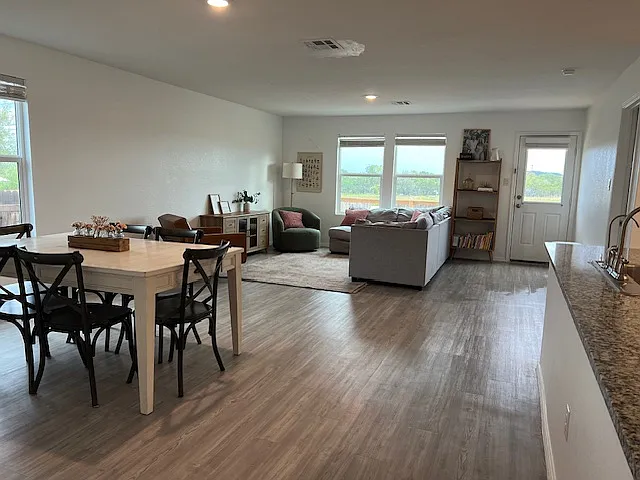 Open floor concept with views of green space out the back. Luxury vinyl plank flooring throughout entire house! - 5808 Dalliance Ct