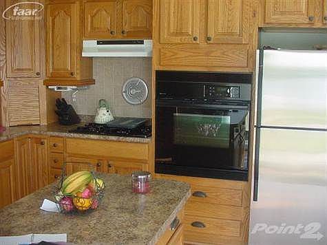 stove top range and oven with center island and stainless steel frig