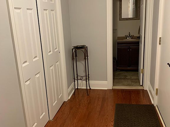Hallway off kitchen with double closet & 1/2 bath