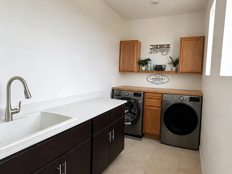 Laundry area with sink and counter