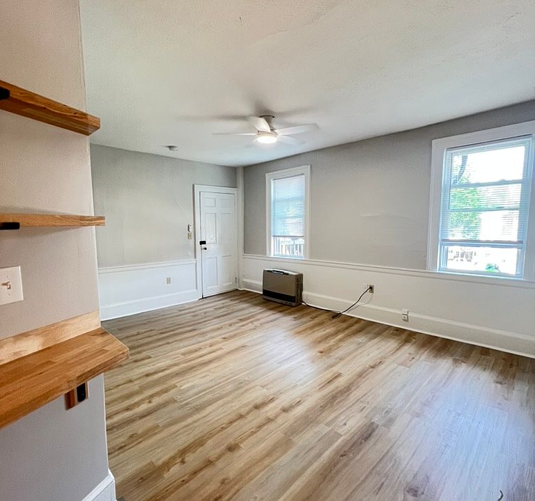View of living room and entrance from the kitchen - offers LVP flooring, energy efficient windows and ceiling fan