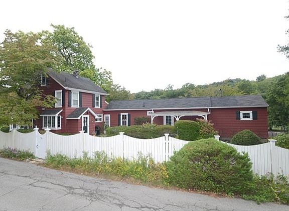 Front view of "Early Bird Farm" with white picket fencing