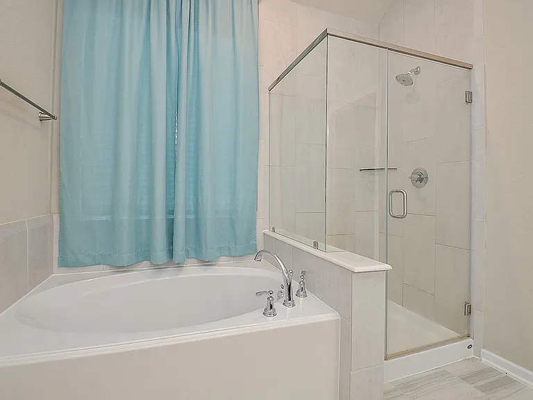 Primary/Master bathroom. Full size walk-in shower. Full size luxury bathtub.