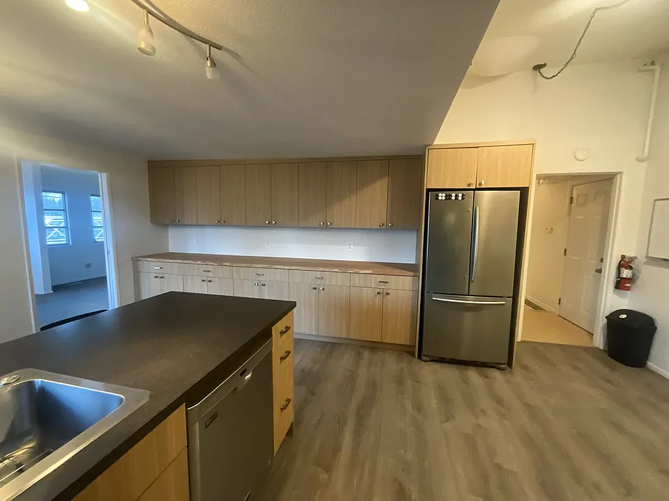 Kitchen facing the entryway and dining room