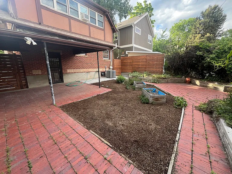 View of patio facing the back of the house. The brown covered area was planted with clover which is currently growing in.